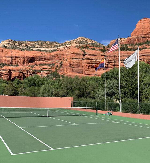 Tennis Court with Red Rocks in Background and flags