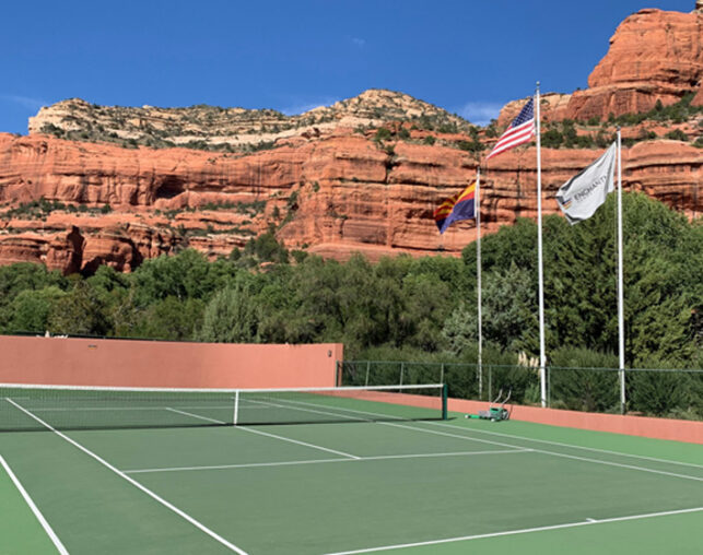 Tennis Court with Red Rocks in Background and flags