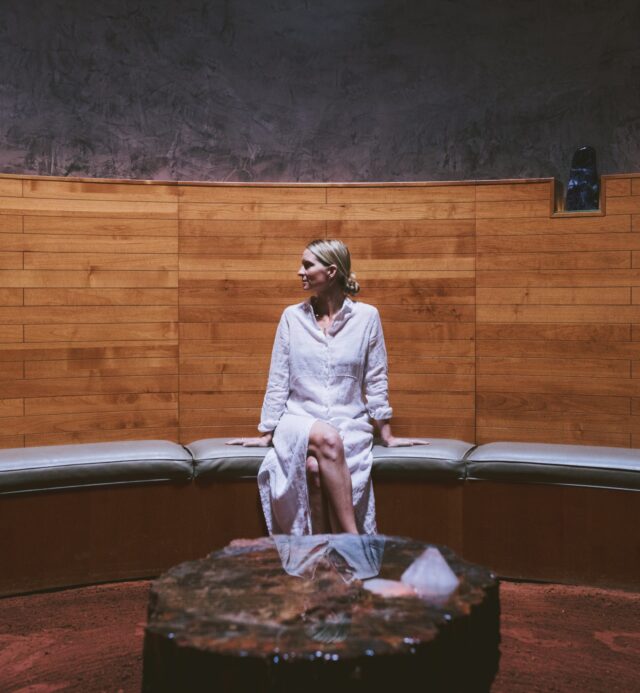 Woman sitting inside the Crystal Grotto spa.