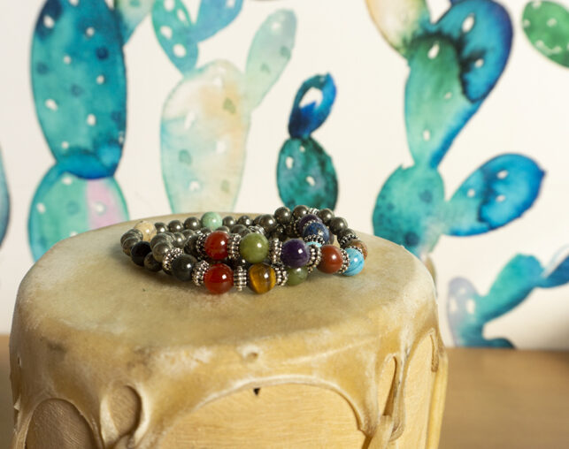 Beaded bracelet sitting on tan drum with cactus wallpaper in background