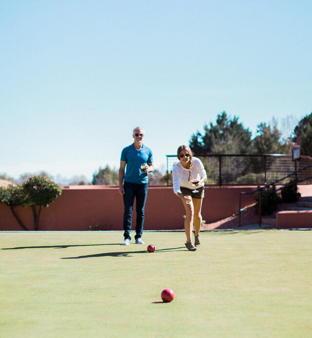 two adults playing bocce ball