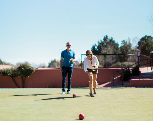 two adults playing bocce ball