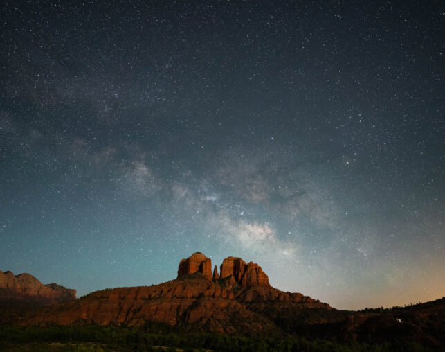 dark starry sky with mountain in distance