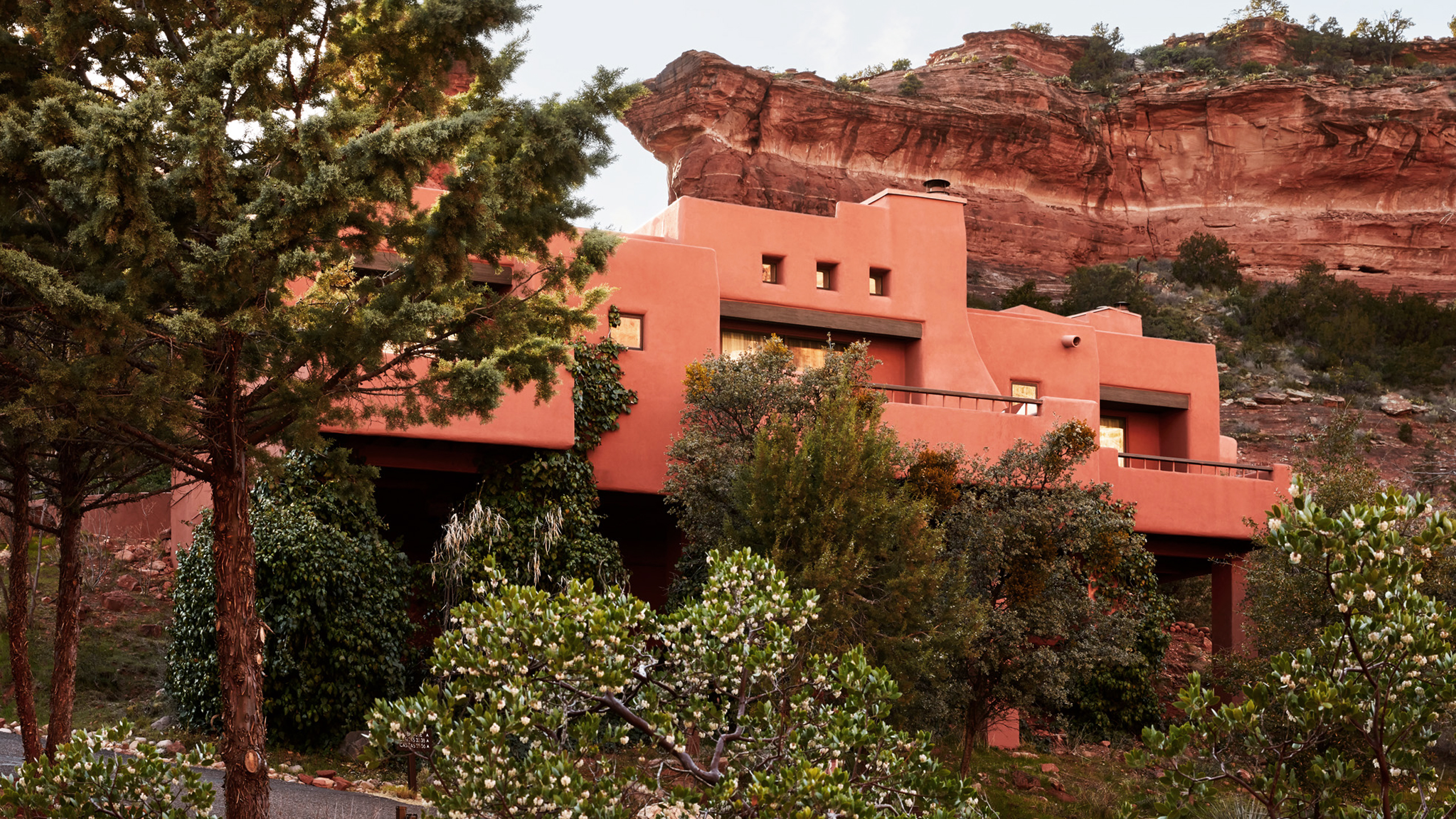 Red rock with casita in front and pine trees