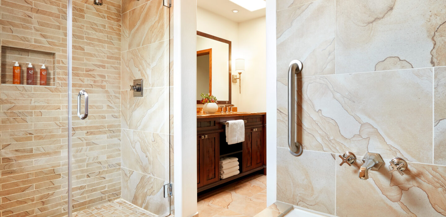 marble bathroom with glass shower and tub