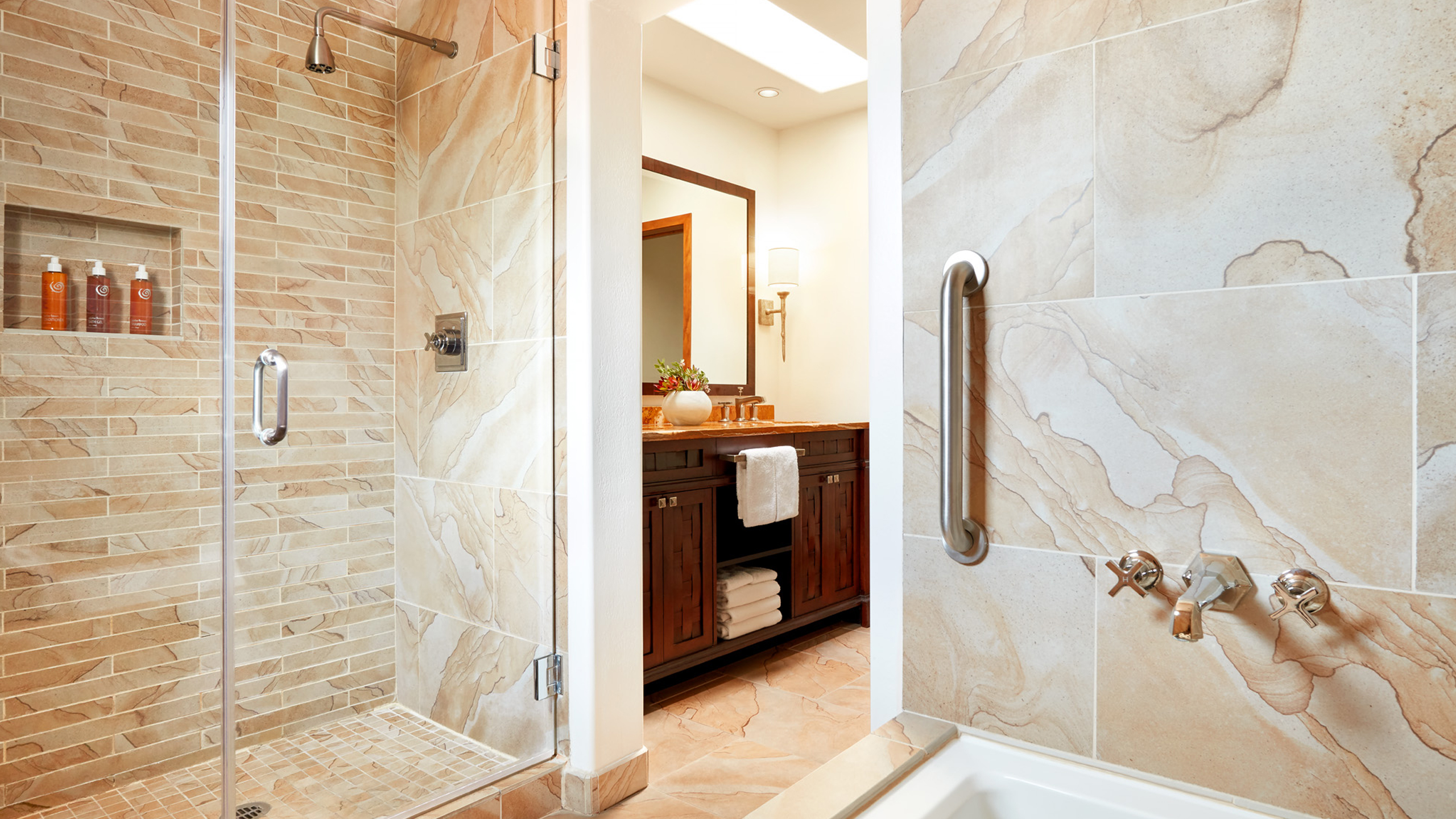 a bathroom with a shower, sink, and mirror