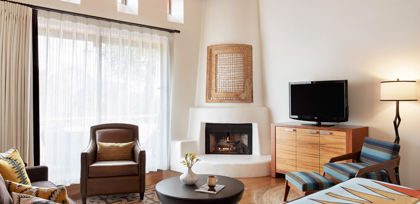 Living area with couch, tv, fireplace and chairs