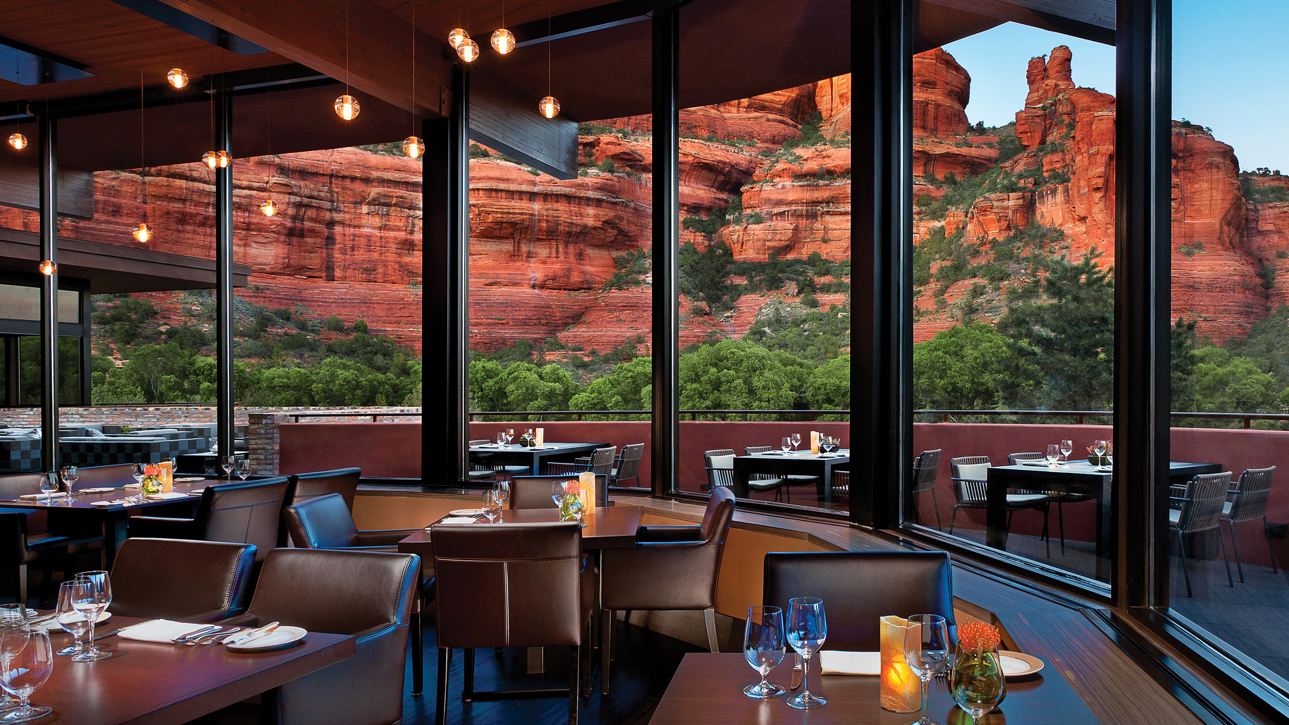 inside of restaurant with dining tables and big windows