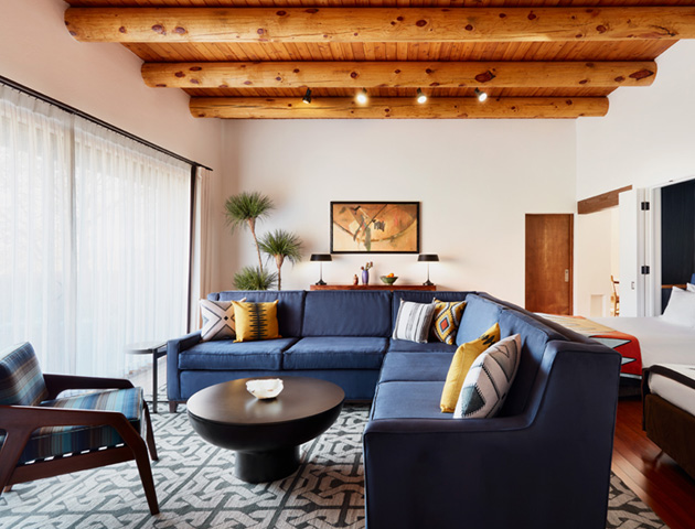 hacienda suite with blue couch and wood beamed ceiling