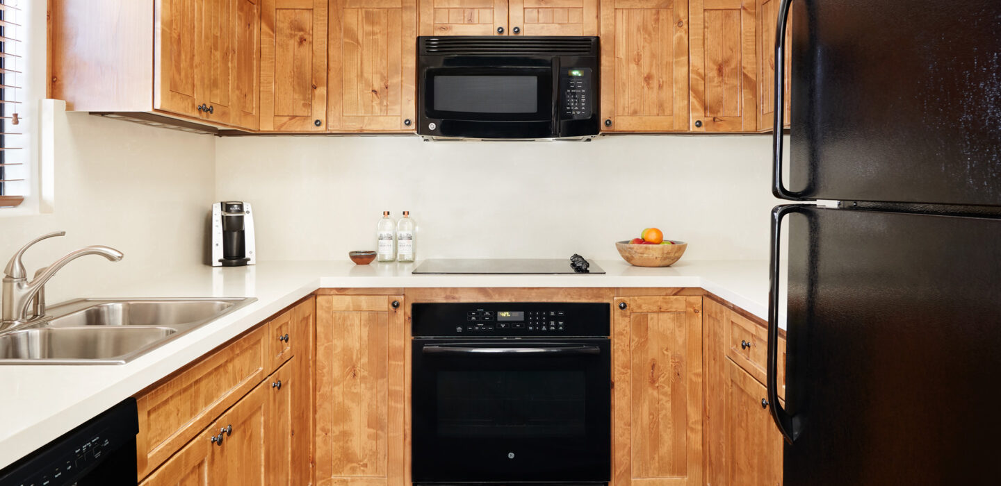 Hacienda 1 bedroom kitchen cabinets and black appliances