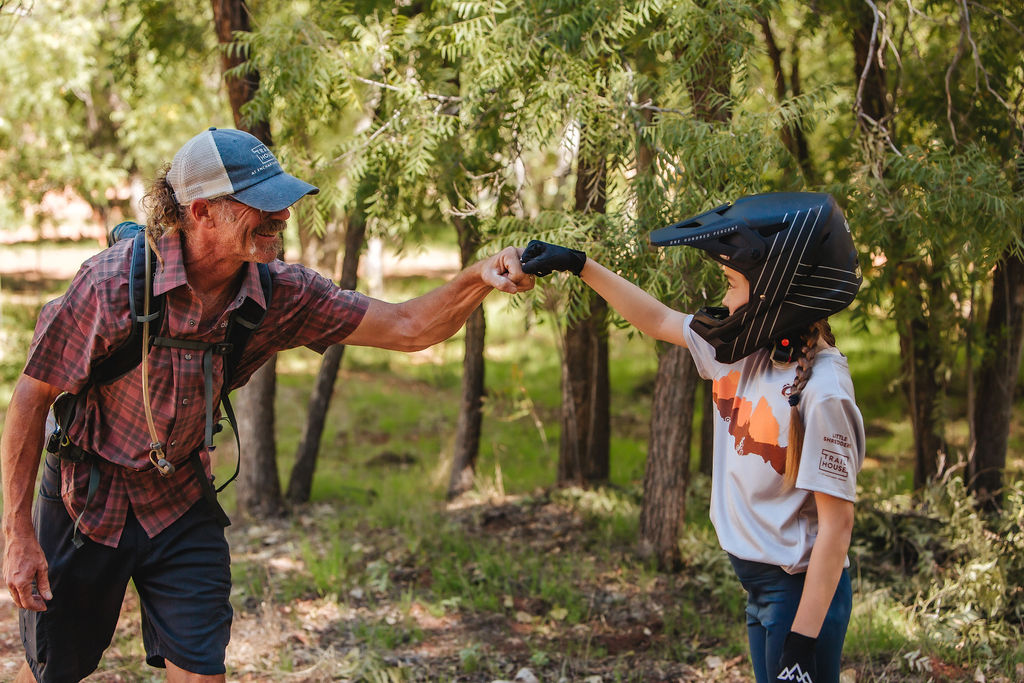 Biking guide, Doug Coop, praising one of his kids in the Little Shredders group at the Trail House