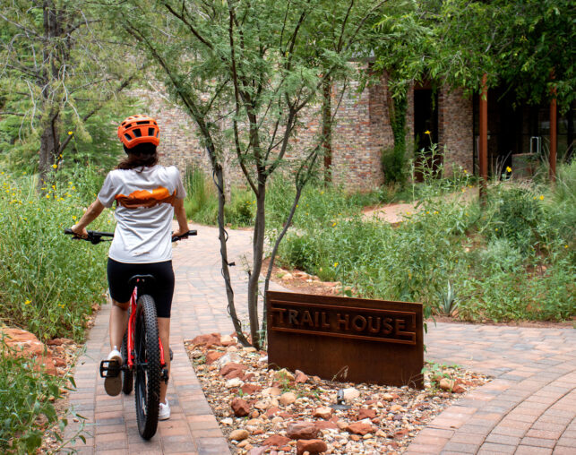 little girl on mountain bike with orange helmet