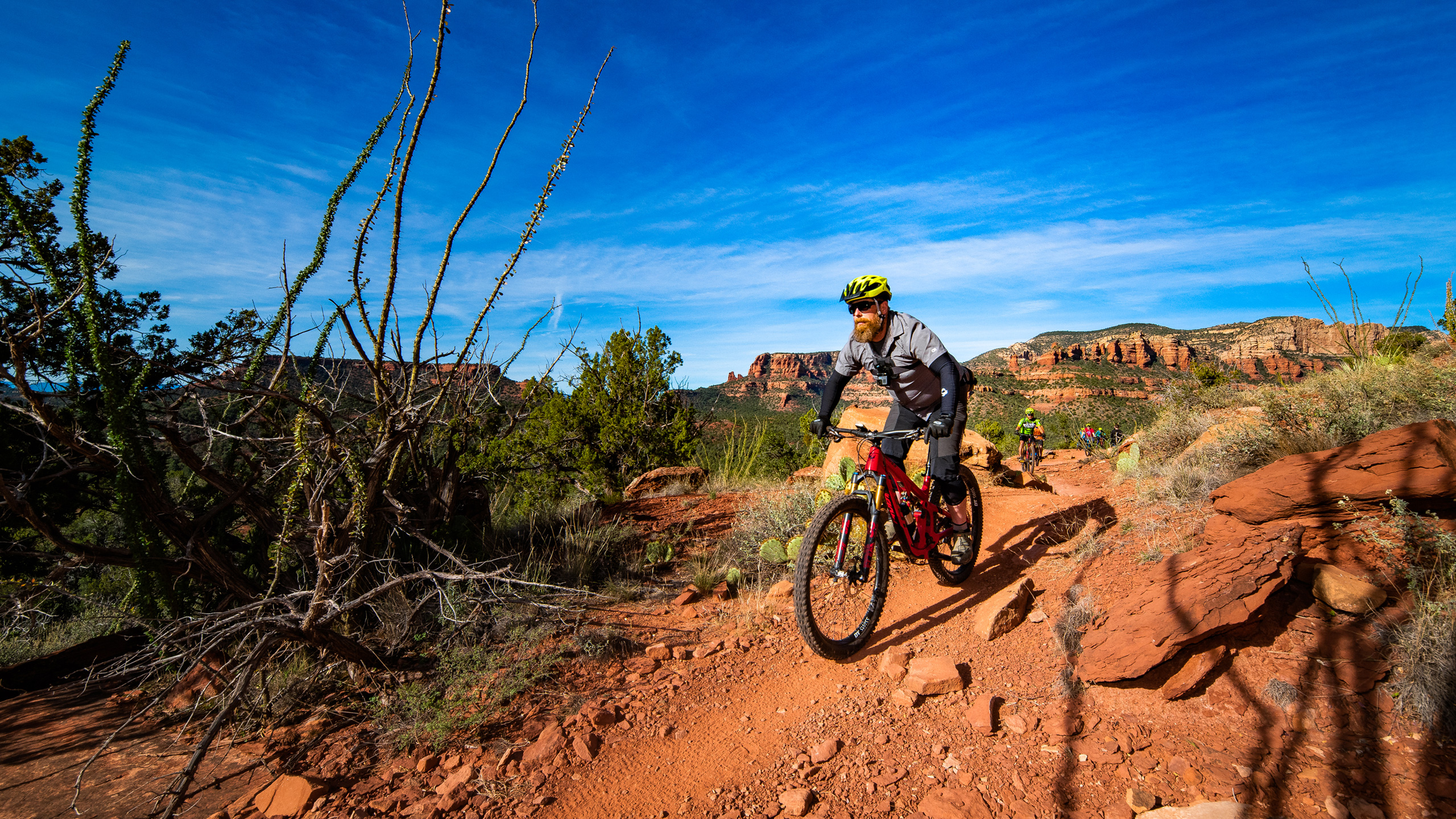 mountain biker on trail with blue sky