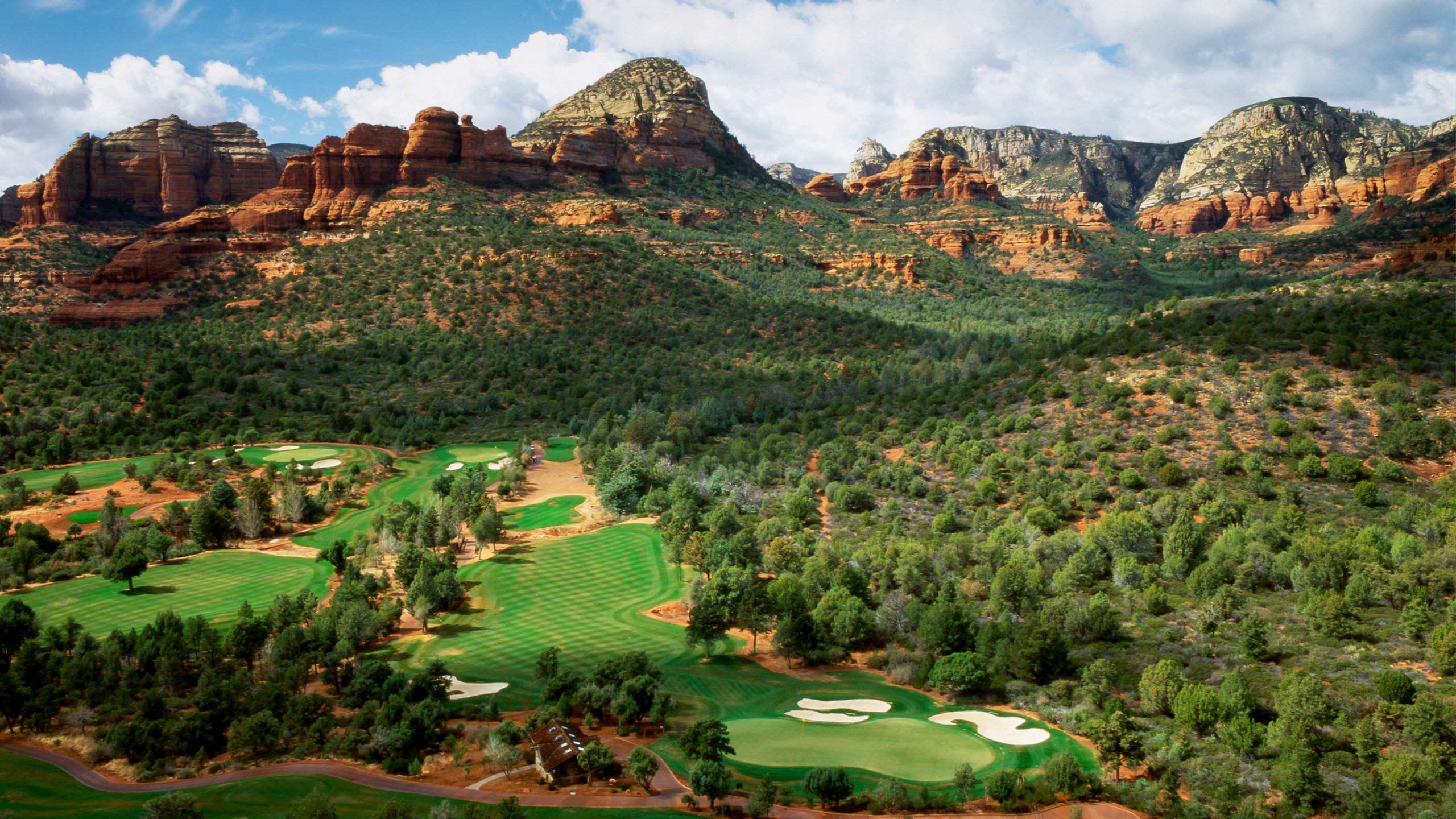 golf course with red rocks in backdrop