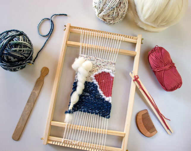 weaving loom and balls of yarn