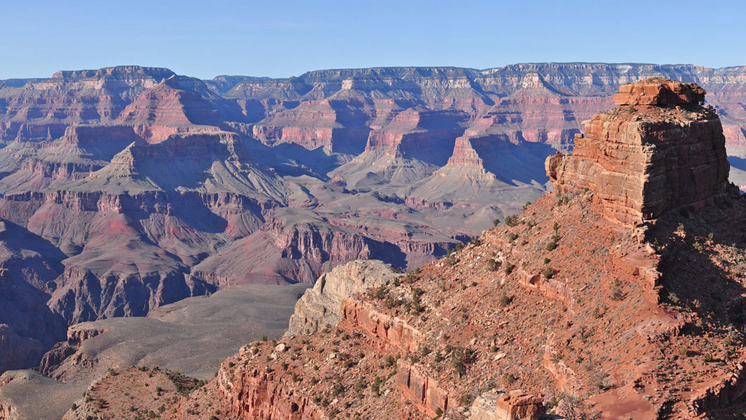 orange rock formation in grand canyon with blue sky