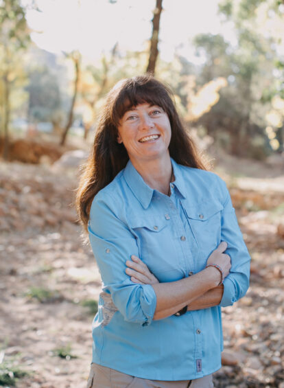 Portrait of Nina Rehfeld surrounded by the trees of Sedona at the Trail House