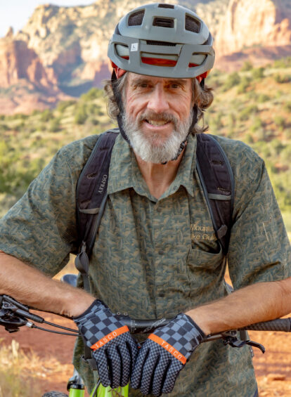 man wearing mountain biking helmet and gloves