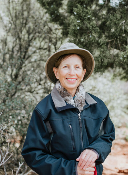 Female hiking guide Carla Williams wearing a blue jacket and hat at our Enchantment Resort Trail House