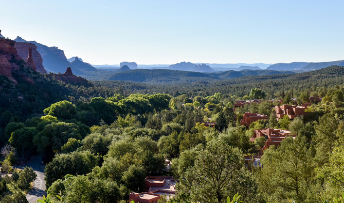 View of resort and red rocks with greenery