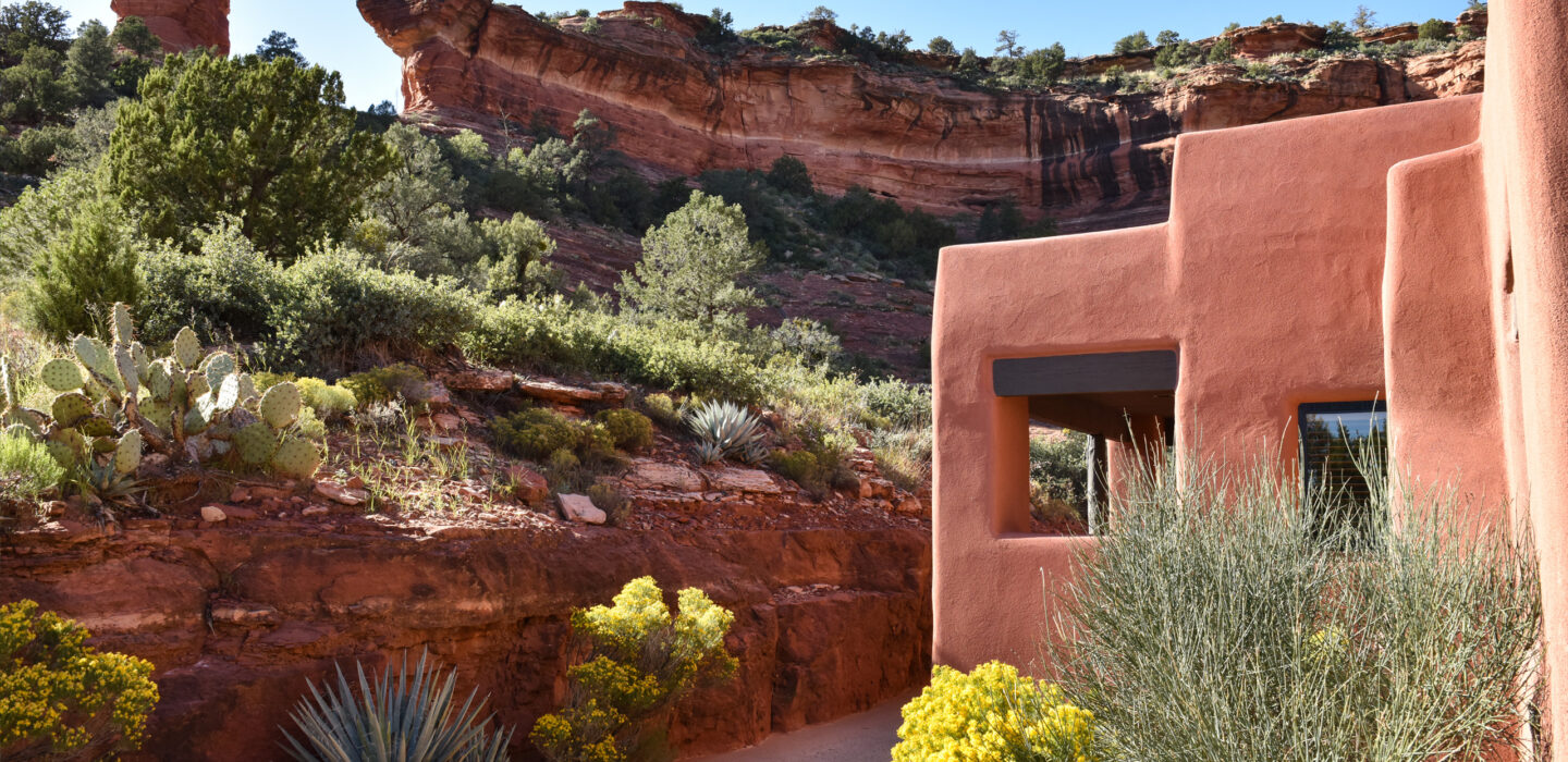 casita with yellow flowers and red rocks