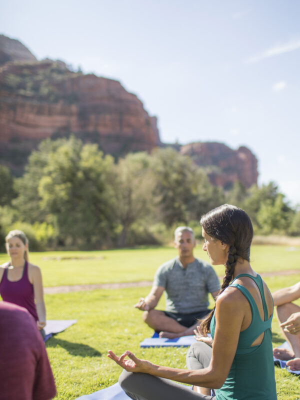 people sitting outside doing yoga