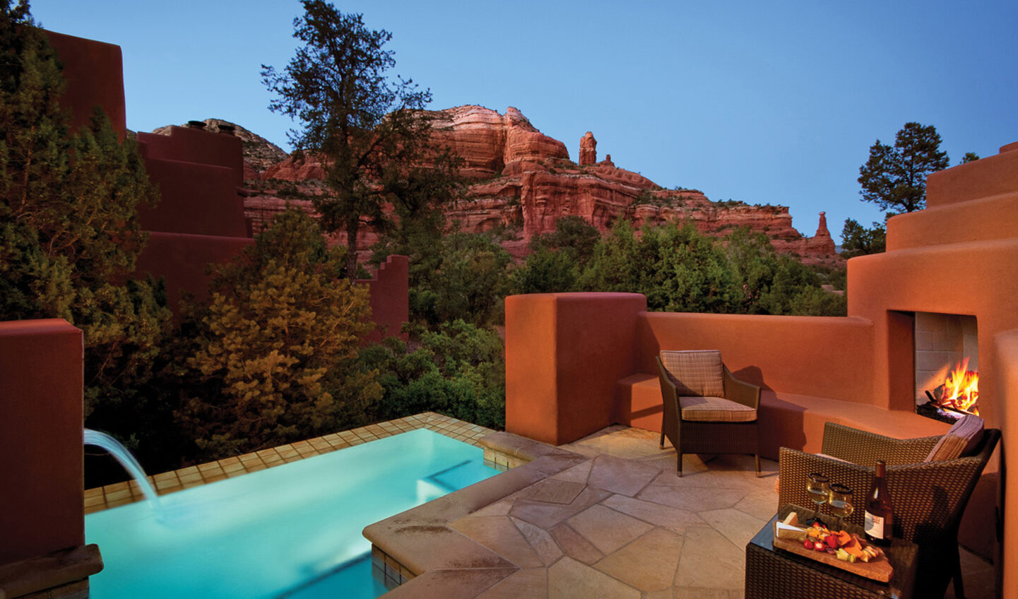 private pool with fireplace at dusk