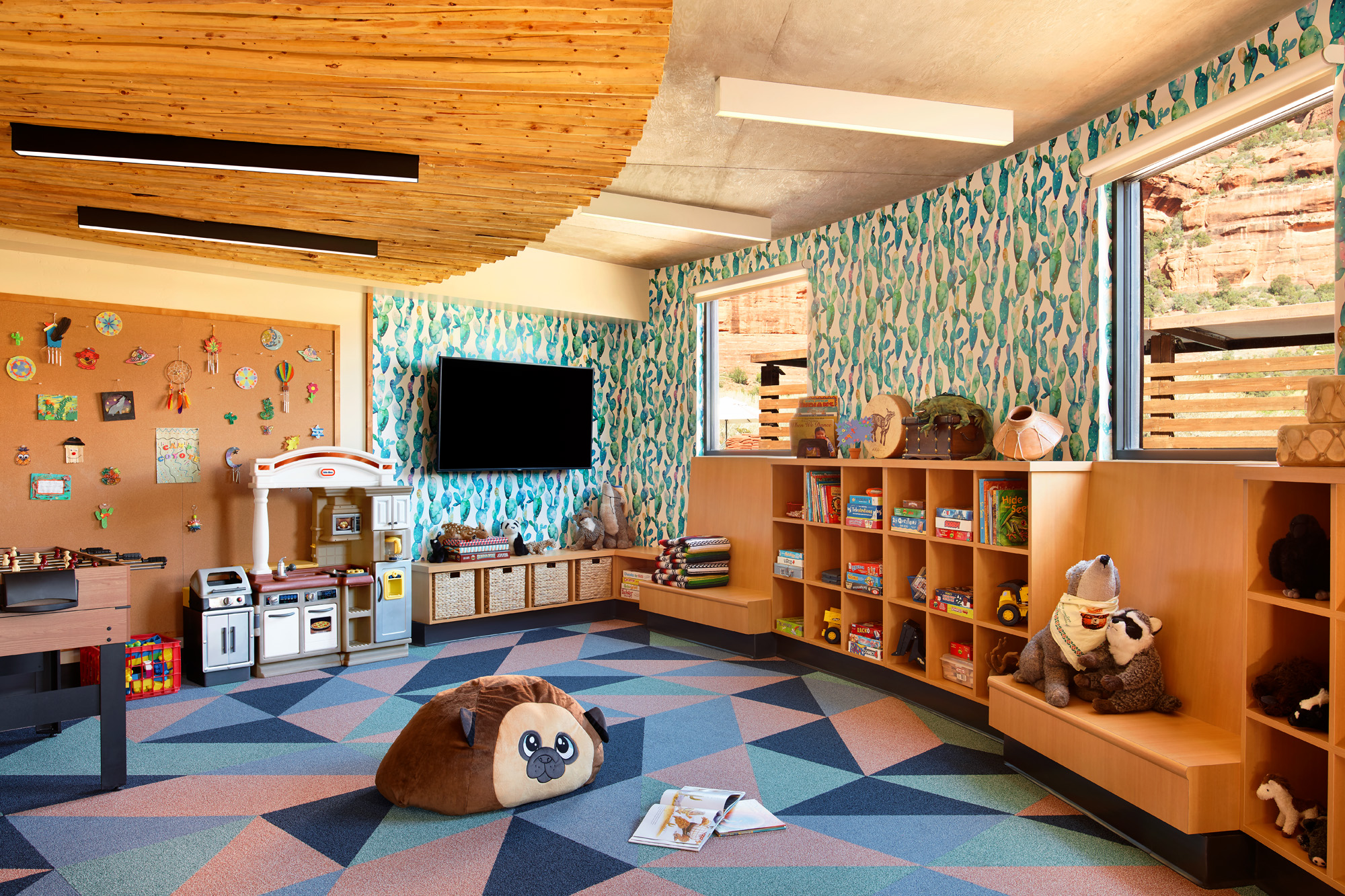 interior of kids camp building with bright geometric carpet and toys