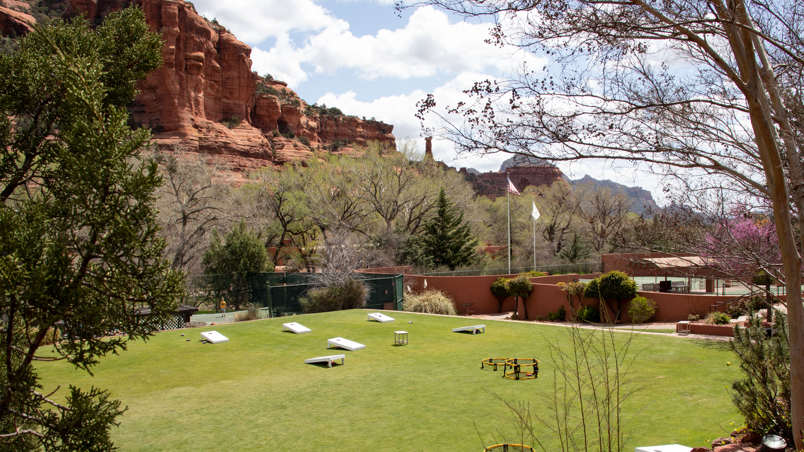 Enchantment Resorts lawn Games set up on a vibrant green lawn with the Red Rocks behind it