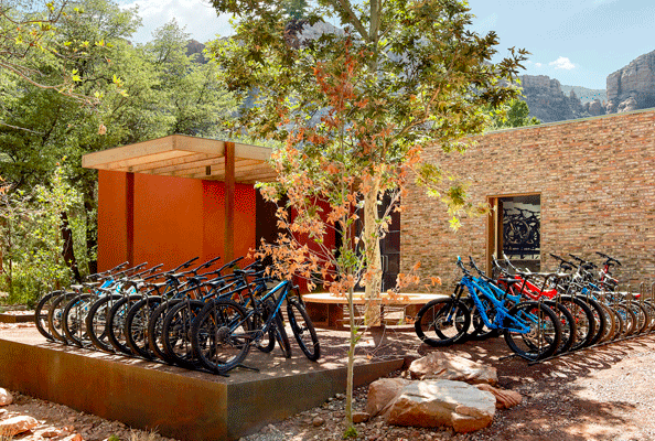 Several bikes neatly lined up outside a buidling