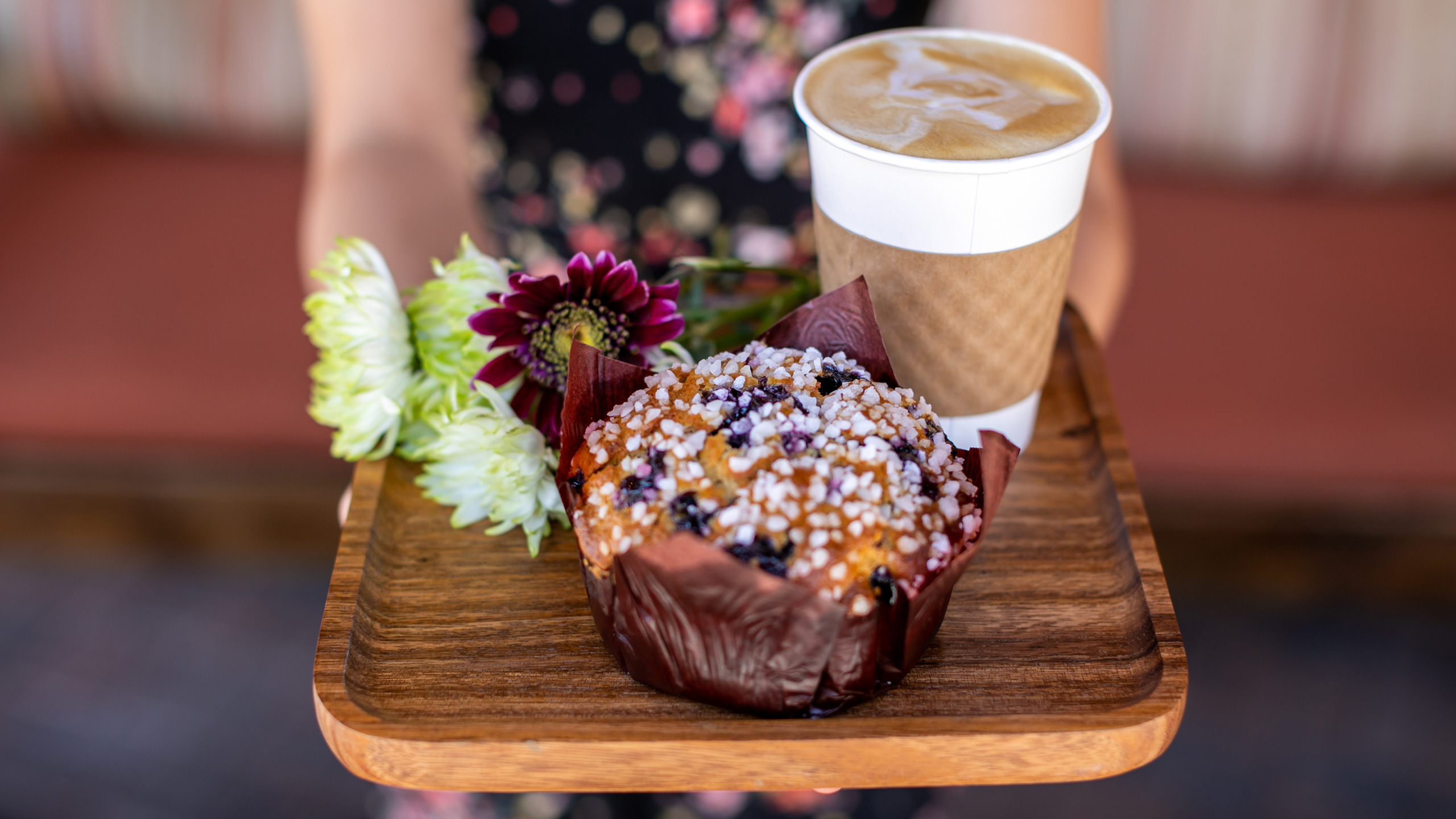 wooden tray with flowers, large blueberry muffin and coffee