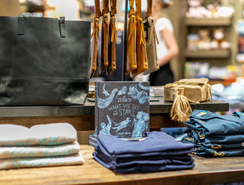 table with leather purses and folded shirts