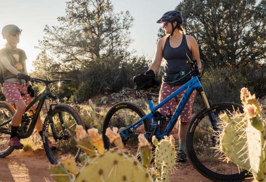 two women mountain bikers stopped on trail