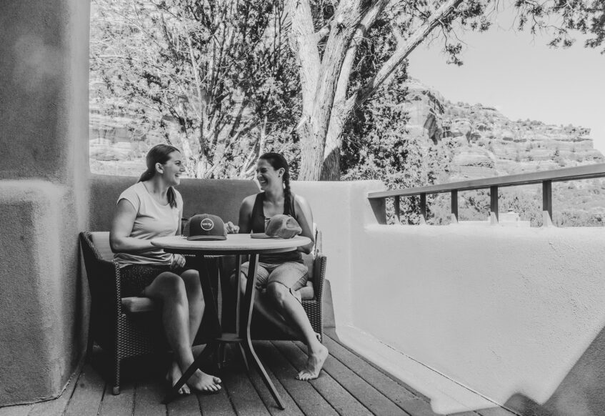 two women talking on patio