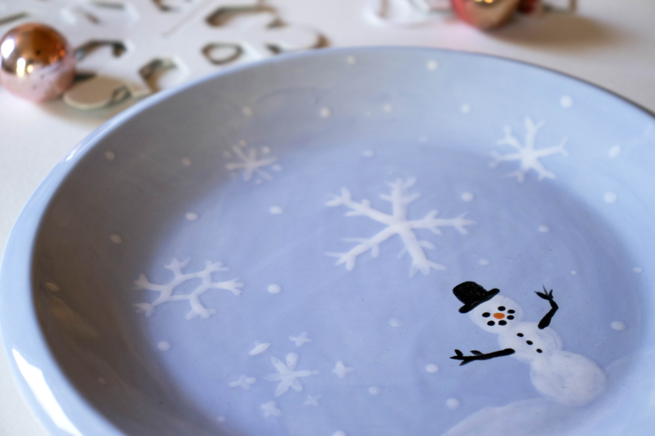 blue plate with snowman on it