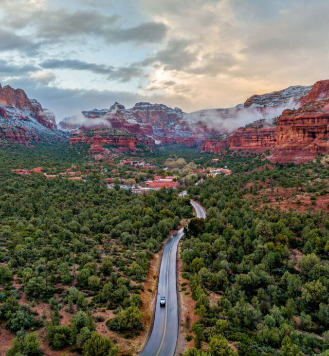 snow capped red rocks in sedona with storm clouds