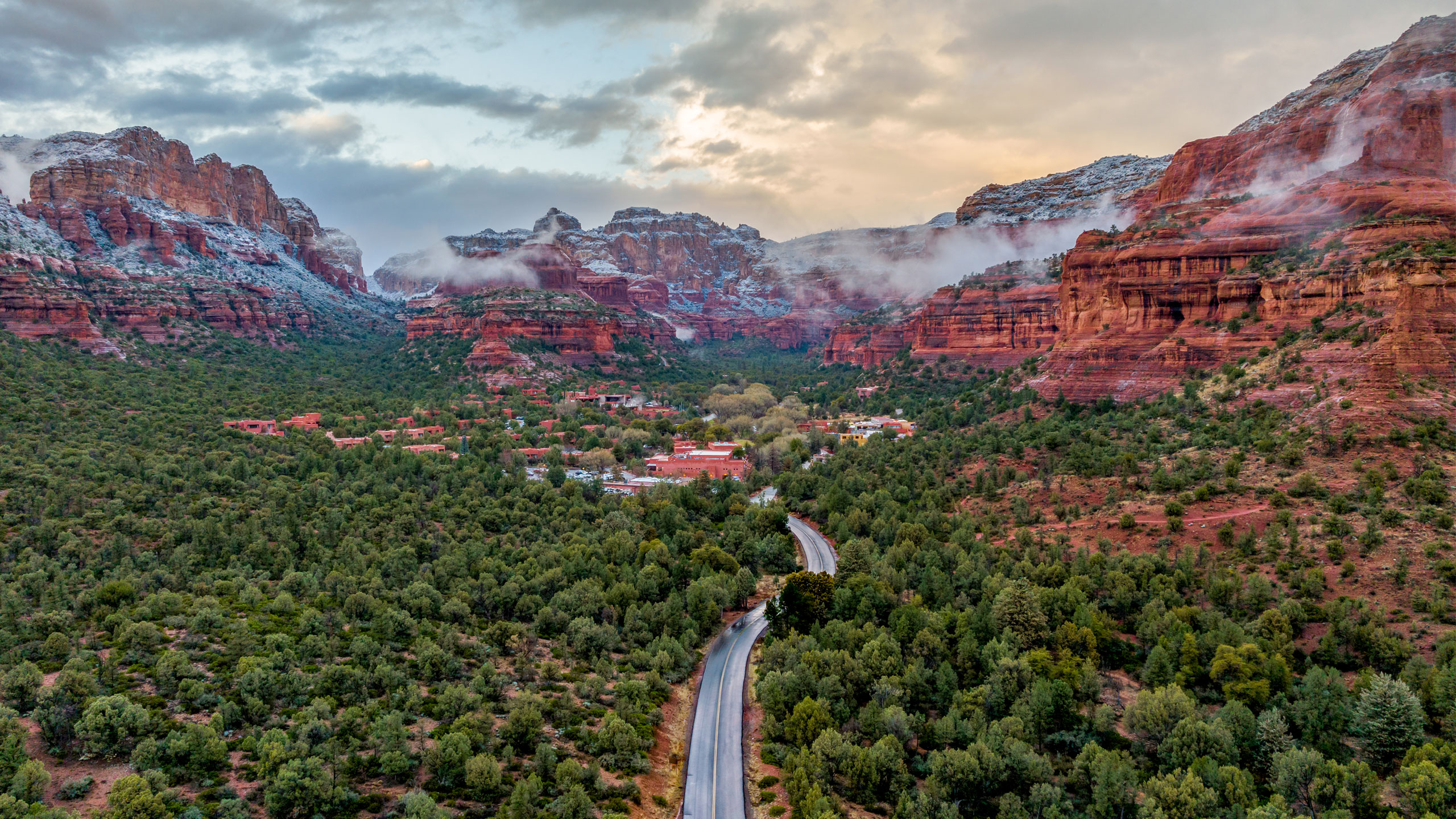 snow capped red rocks in sedona with storm clouds
