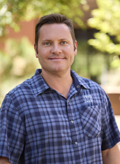 male Trail House guide in blue shirt