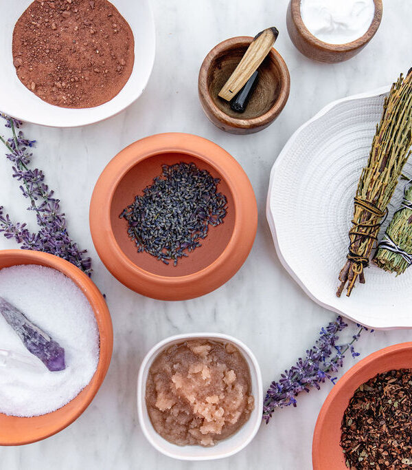 overhead view of small bowls and plates filled with salts and herbs