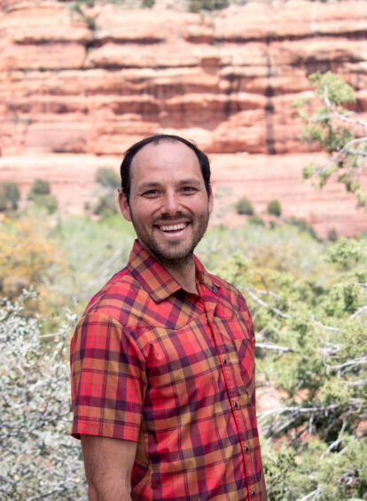 image of a smiling Paul Butler with the red rocks of Boynton Canyon behind him