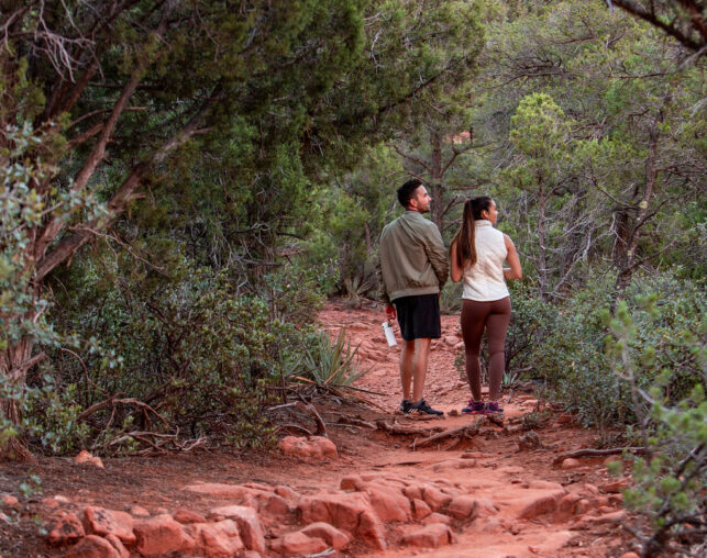 a couple hiking on red rock trail