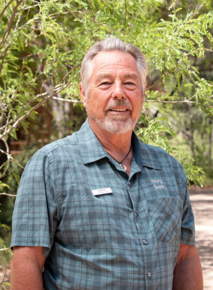Kelly Geno a hiking guide at Trail House wearing a blue plaid shirt