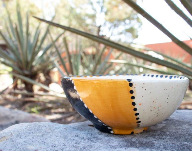 yellow and black painted pottery