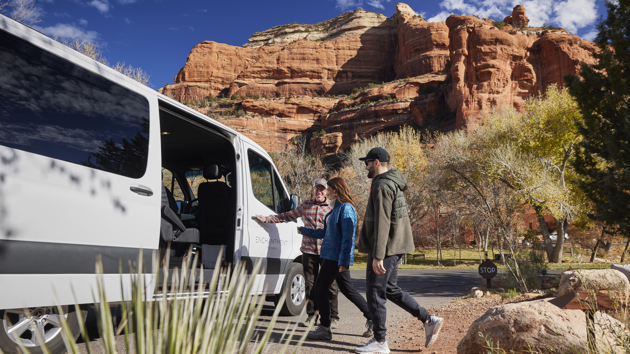 Driving Tours at Enchantment Resort, couple entering tour van with red rocks in background