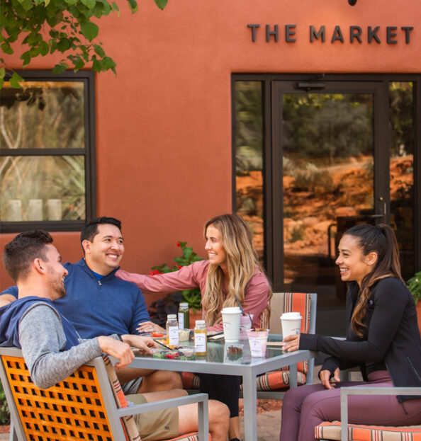 group of friends at the market enjoying coffee