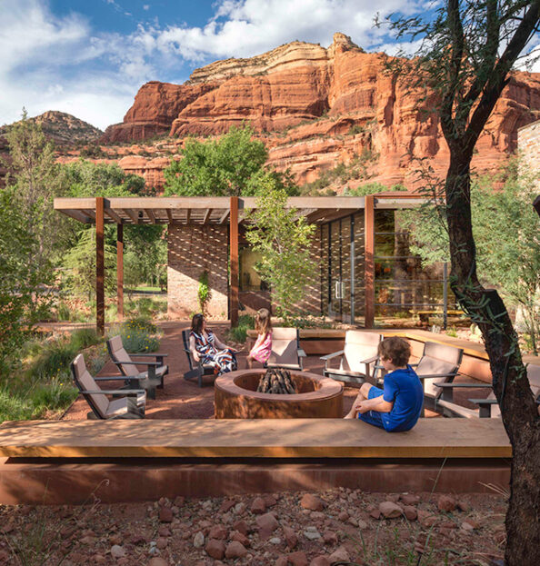 Trail House exterior with family and red rock view