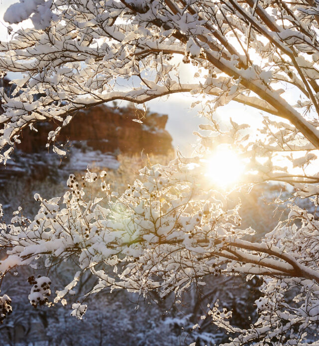 sun coming up over the snowy sedona red rocks