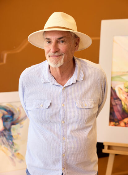 male artist with white shirt and hat
